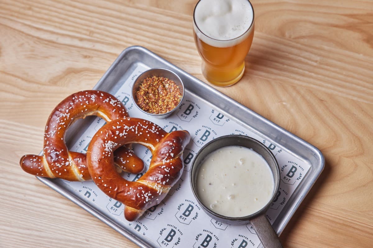 pretzel with cheese and glass of beer