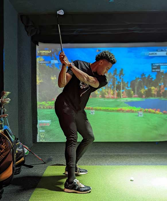 Aaron swinging a golf club in a Swing Suite