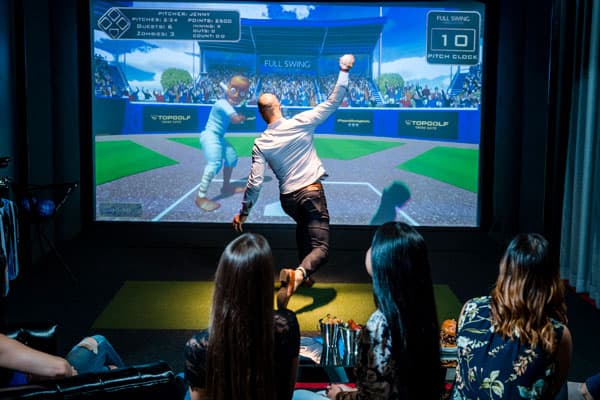 Man throwing a baseball in Topgolf Swing Suite